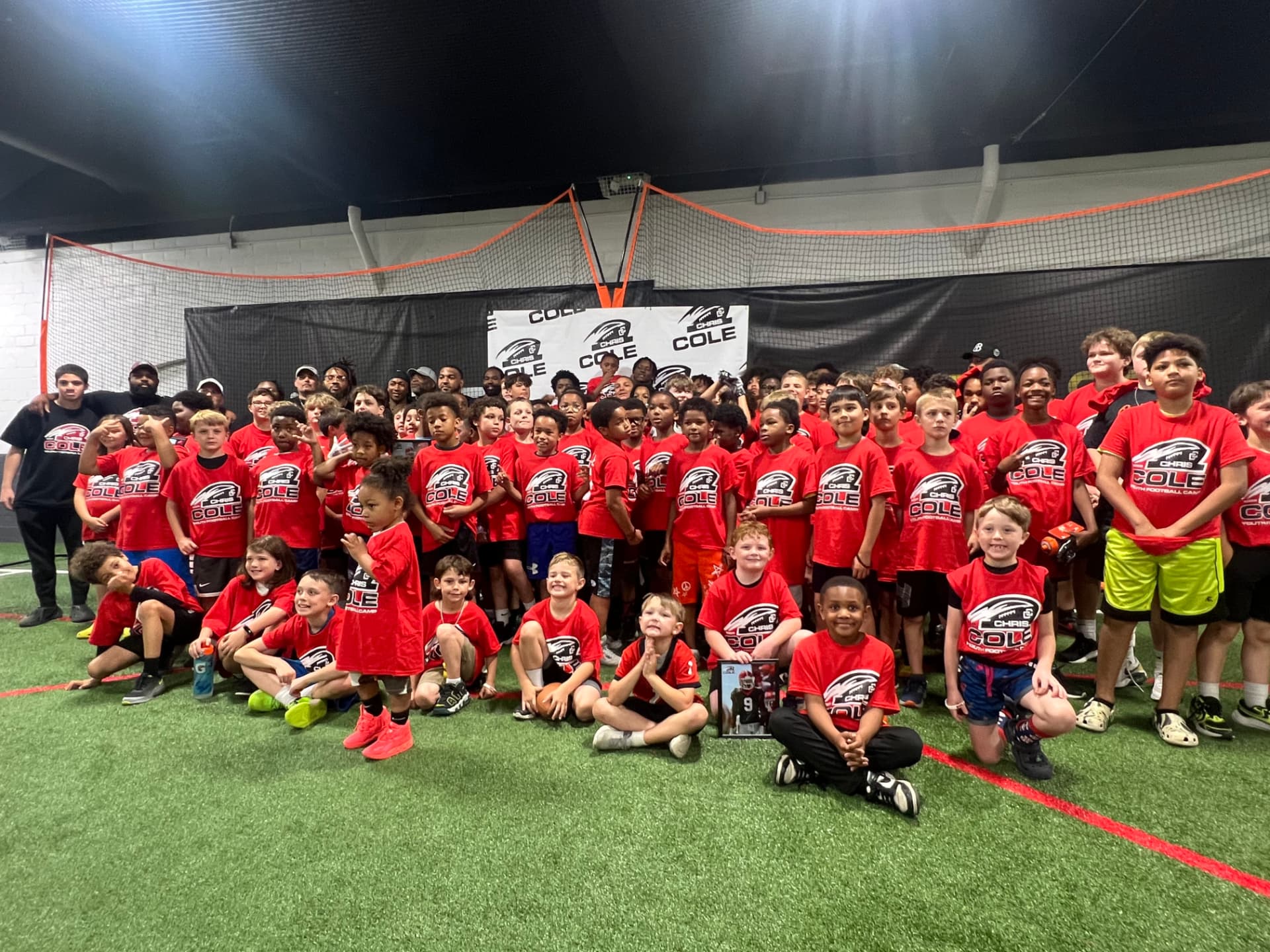 The full Chris Cole Youth Football Camp group photo on the indoor field